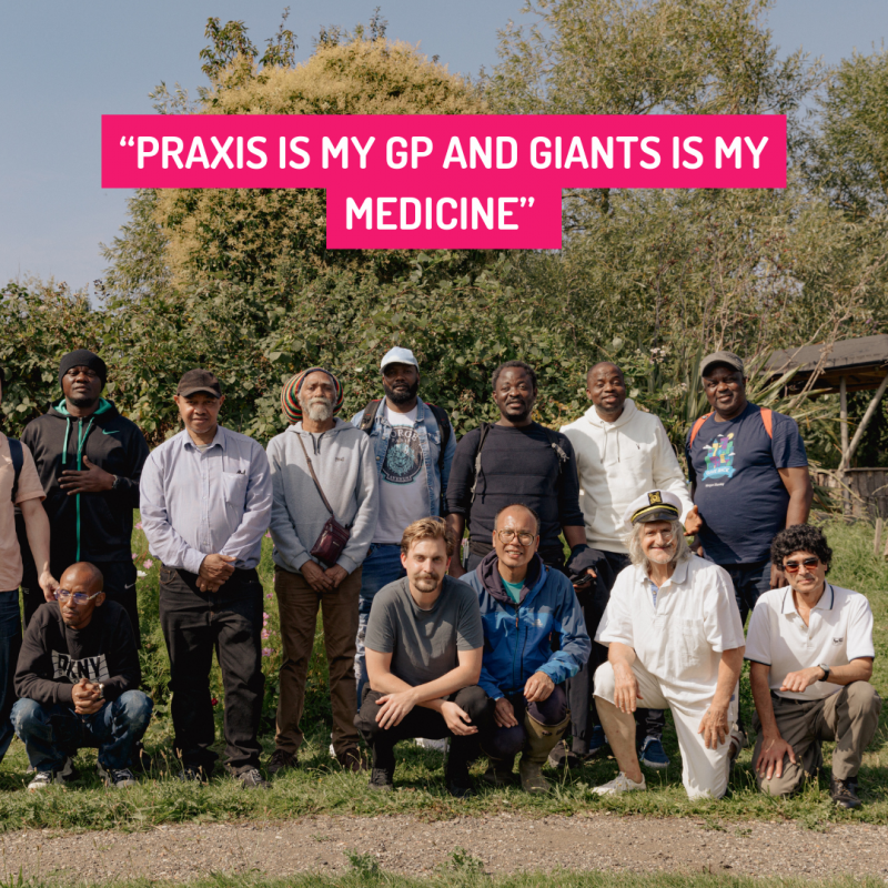 GIANTS group members stand together smiling in front of greenery. Text overlaid says "Praxis is my GP and GIANTS is my medicine"